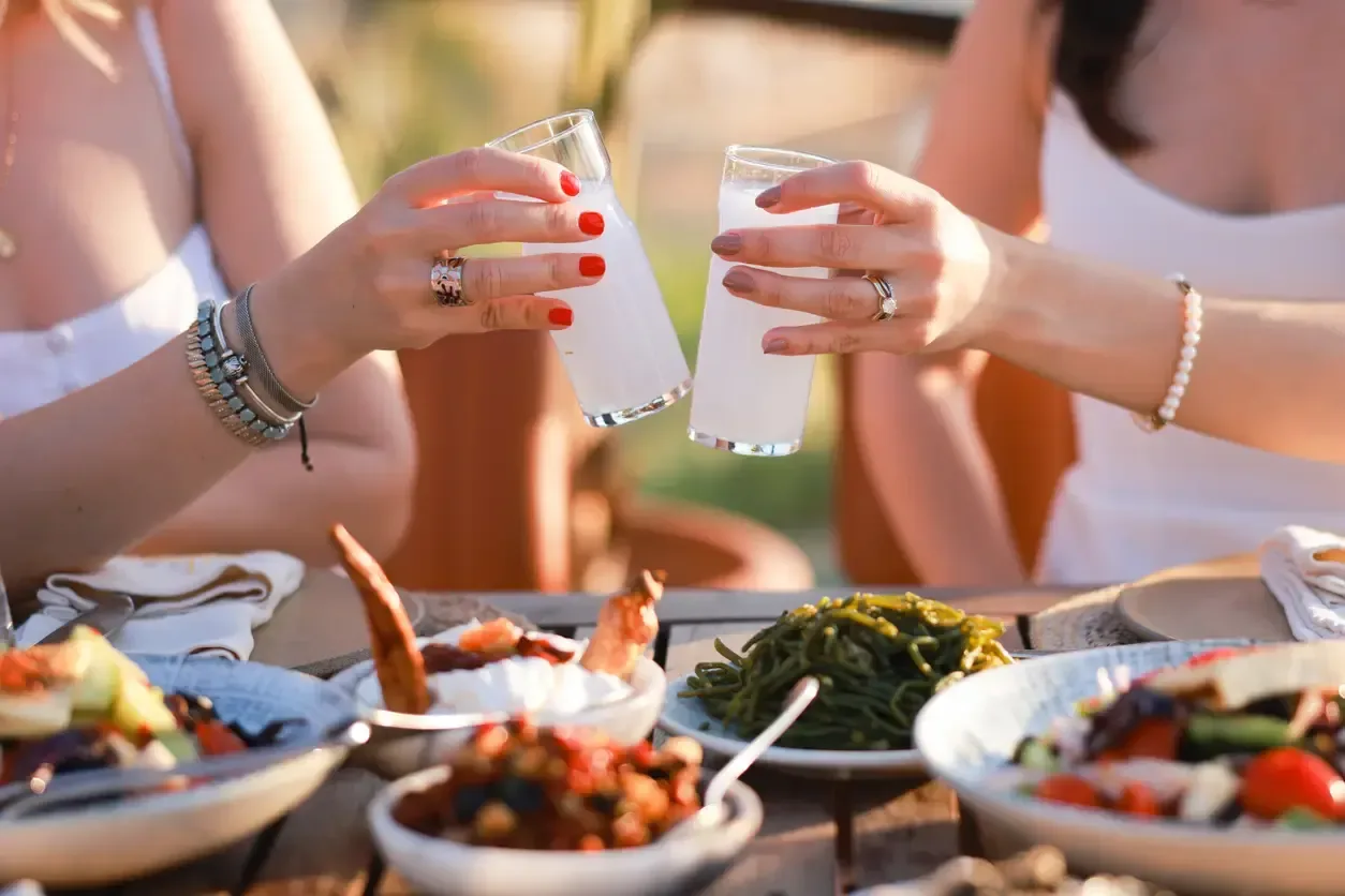 Young Women drinking Turkish Raki with Friends