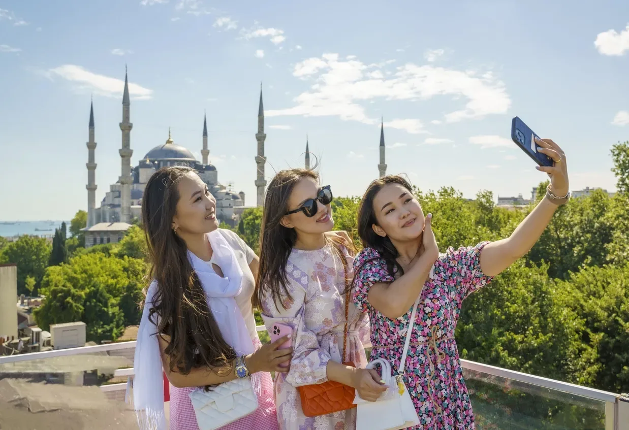 three-women-taking-selfie-rooftop-blue-mosque-sultanahmet-istanbul-turkey