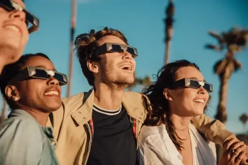 Agroup of Friends Watching Solar Eclipse