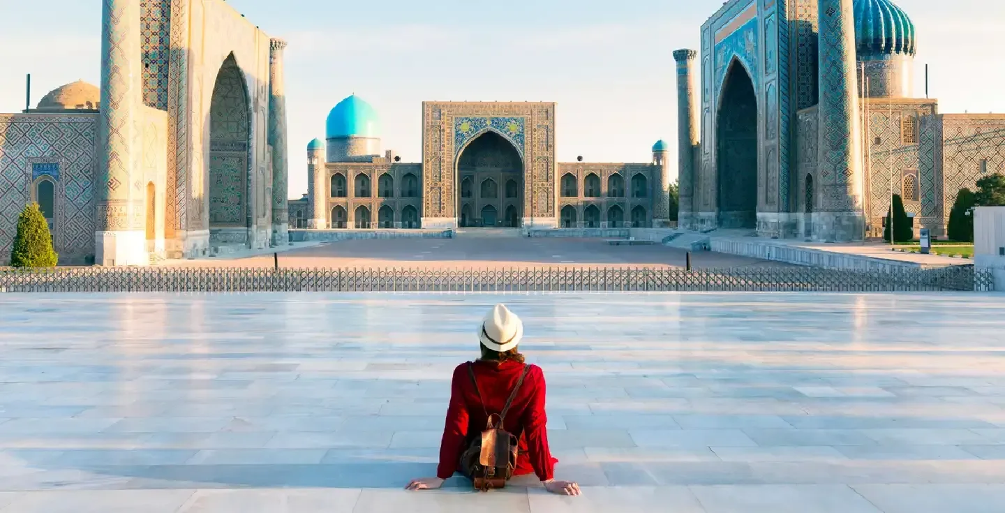 mujer-turista-sombrero-vestido-rojo-registan-samarcanda-uzbekistan