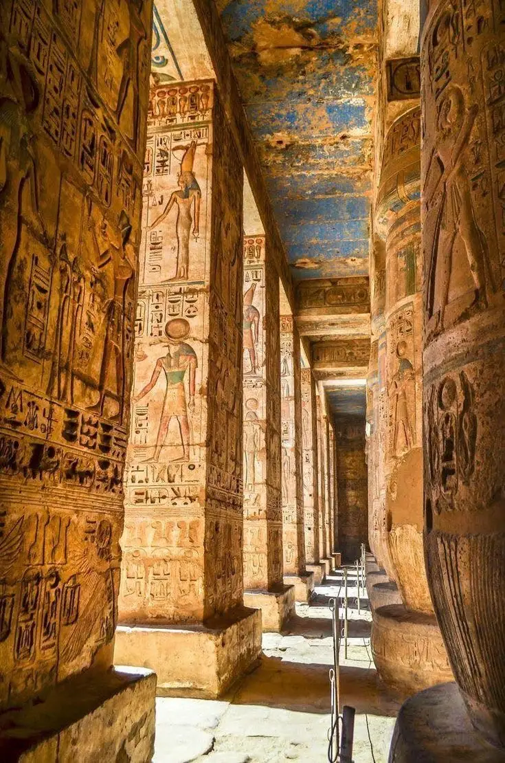 Colorful hieroglyphic carvings and columns inside an ancient temple in Luxor, Egypt