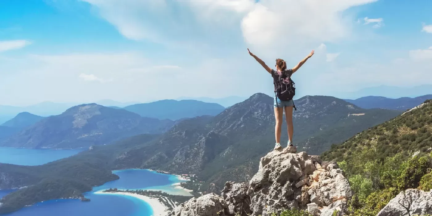 Girl hiking to the top of the mountains in Oludeniz, Activities in Turkey.