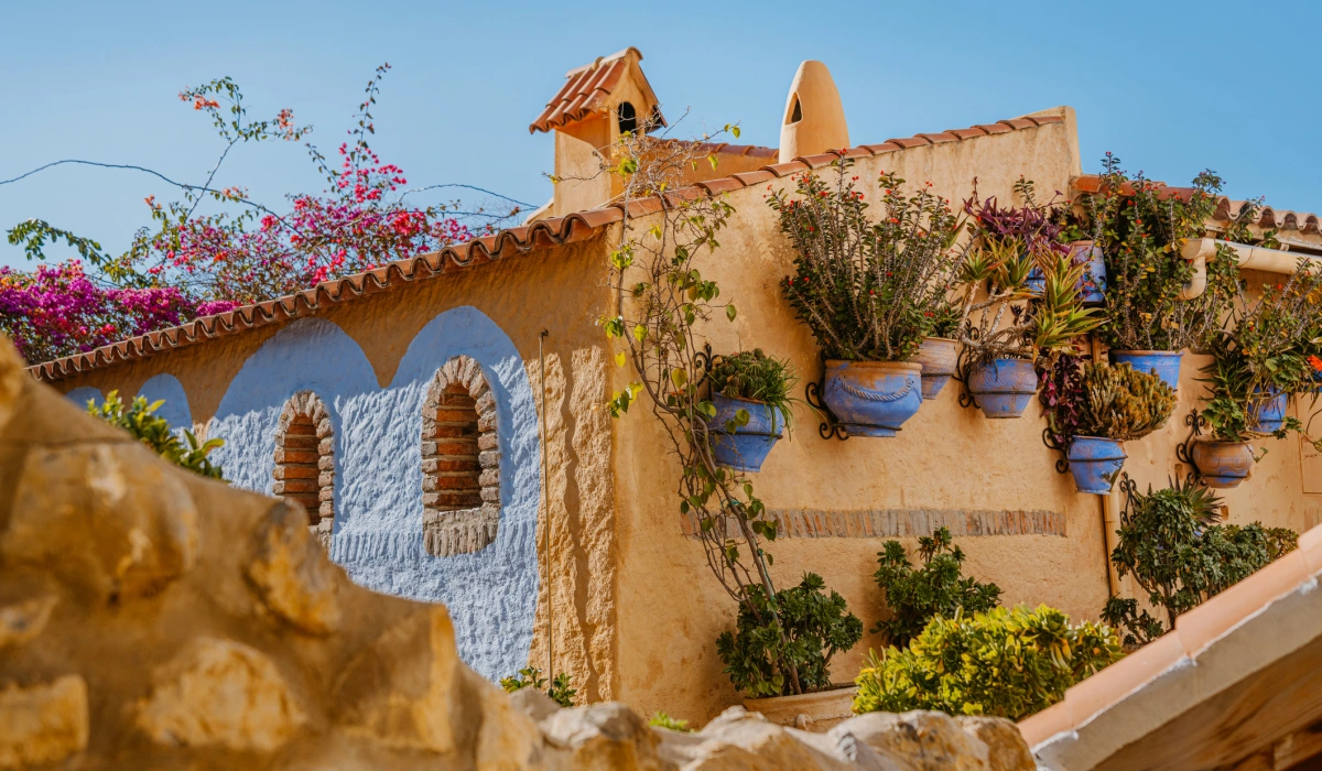 Moroccan Blue-Walled House With Plant Pots and Terrace stock