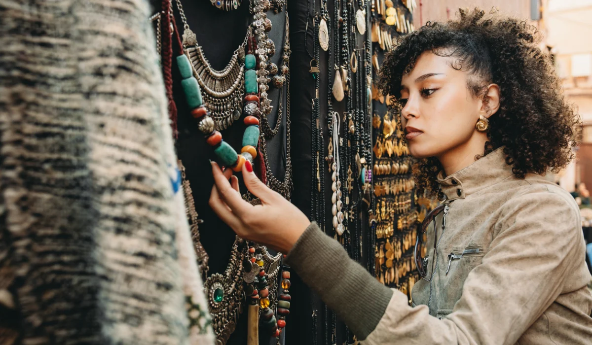 Young woman shopping for handmade jewelry in Marrakech souk