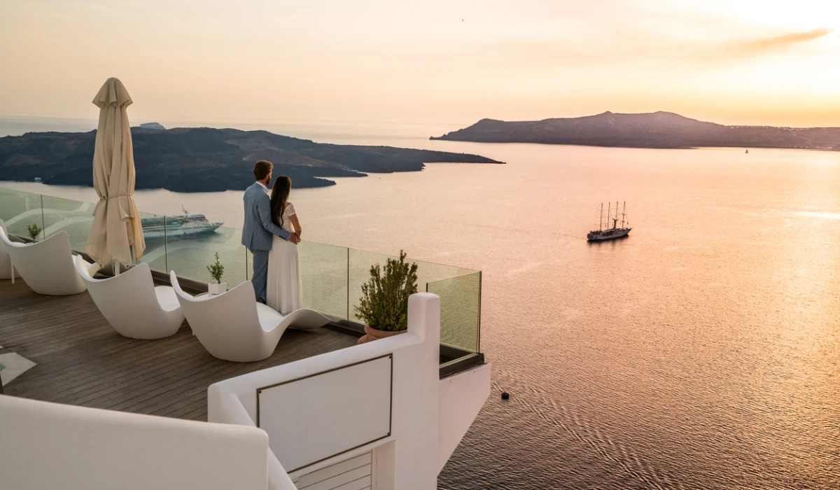 Authentic Wealth - rich couple standing on terrace with amazing sea view