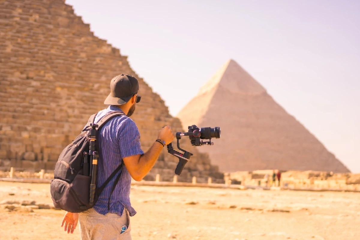 Ein junger Fotograf an der Cheops-Pyramide, der größten Pyramide.