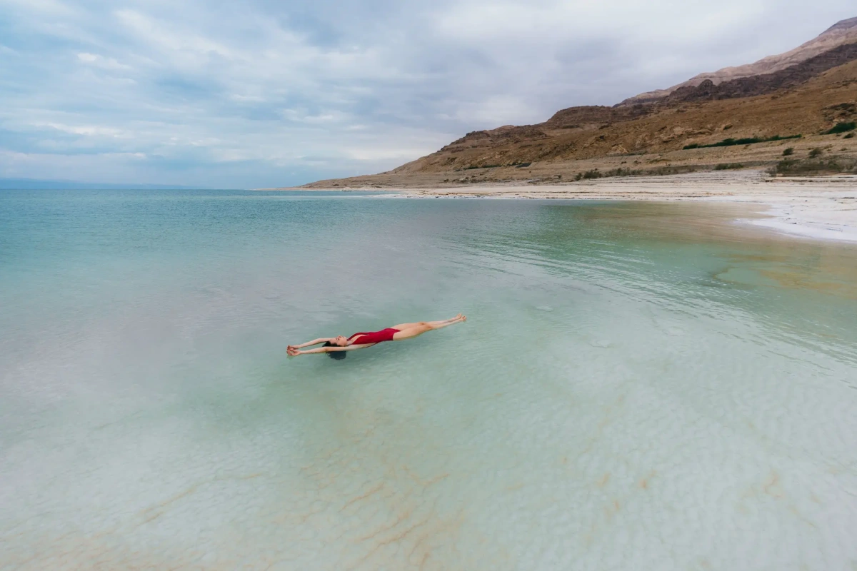 Travelers floating in the mineral-rich waters of the Dead Sea during the Jordan tour