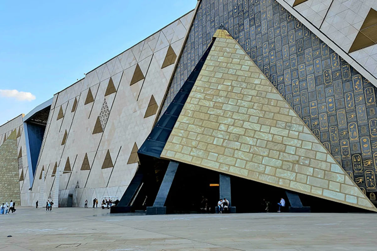 Eingang des Grand Egyptian Museum mit pyramidenförmigem Design und Besuchern