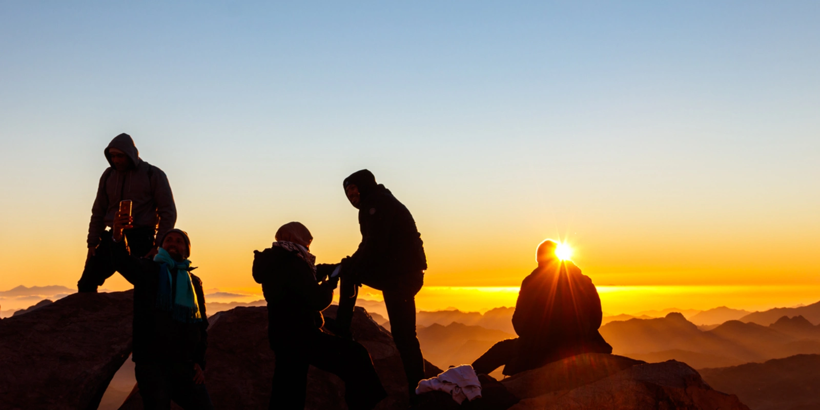 People watching sunrise on the summit of Mount Sinai (Moses Mount) in Egypt