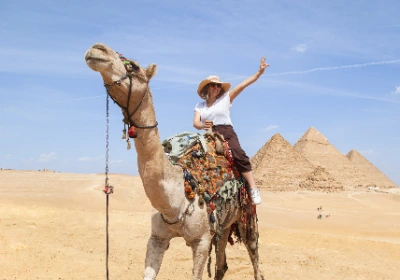 una donna su un cammello davanti alle piramidi, cairo e crociera nilo