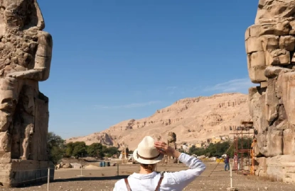 una donna davanti a colossi di memnone, colossi di memnone