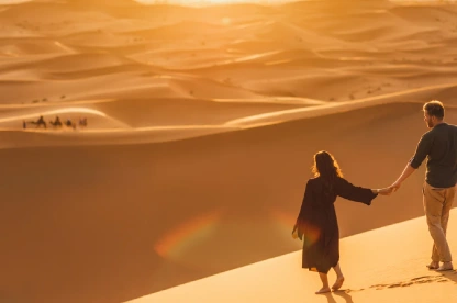 Couple wandering the Sahara desert.