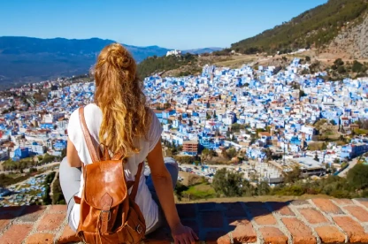 A woman admiring Chefchaouen’s blue streets.