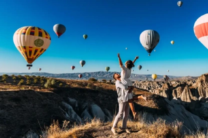 Couple in love enjoying a hot air balloon ride over Cappadocia.