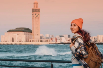 Young woman enjoys the view of Hassan II Mosque in Casablanca.