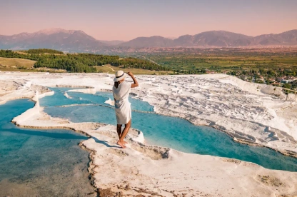 Girl in white outfit enjoying Pamukkale pools.