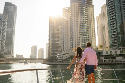 Couple in UAE watching Dubai Marina at sunset.