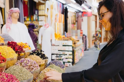 Woman walking through Dubai spice market.
