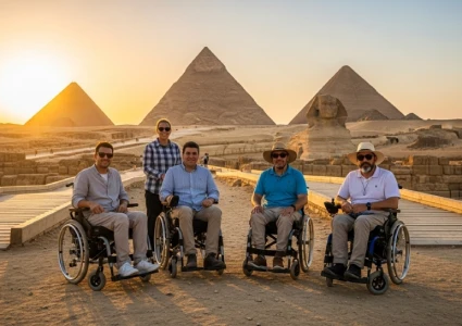   Five wheelchair users pose on a paved path at sunset with the Pyramids of Giza and the Great Sphinx behind them—capturing accessible tourism at Egypt’s iconic heritage site.