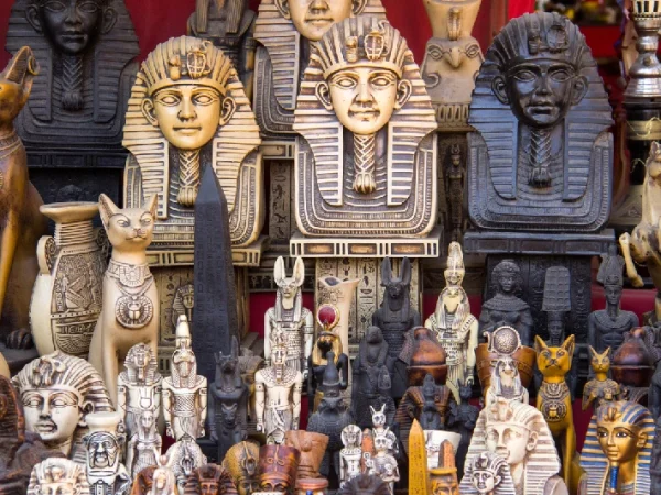 Souvenirstand mit Pharaonenfiguren und Katzenstatuen auf einem ägyptischen Basar