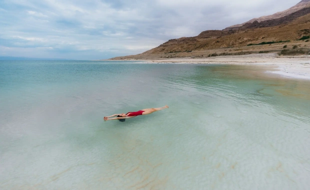 Travelers floating in the mineral-rich waters of the Dead Sea during the Jordan tour