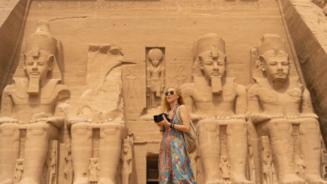 a woman standing infront of abu simble temple 