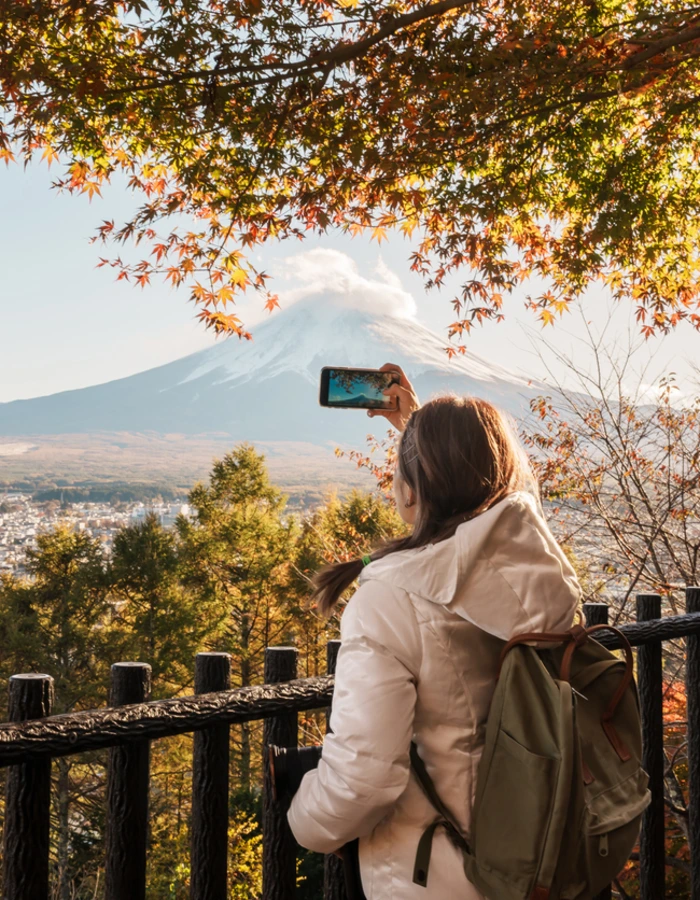 Woman tourist with mount Fuji at Chureito Pagoda in Autumn season, Traveler travel Arakurayama Sengen Park, Yamanashi, Japan. Landmark for tourist attraction. Japan Travel, Destination and Vacation