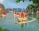 Boats sailing through the emerald waters of Ha Long Bay.