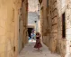 Woman wandering the charming alleys of Rabat’s old city.