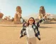 Woman visiting the ancient Colossi of Memnon of Luxor
