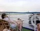 A traveler relaxing on board a Nile cruise while taking in the stunning river views