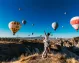 Couple watching hot air balloons in Cappadocia.