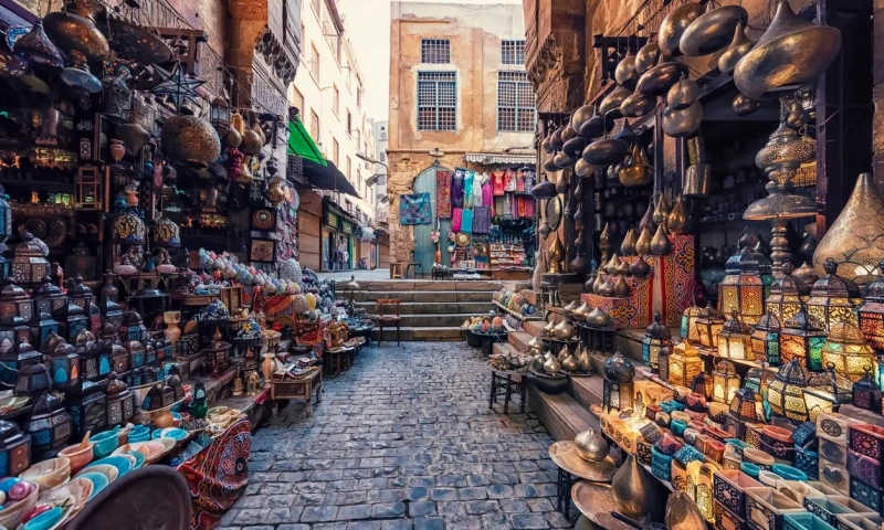 Traditional shops lining a narrow lane in Cairo's Khan el-Khalili market area.