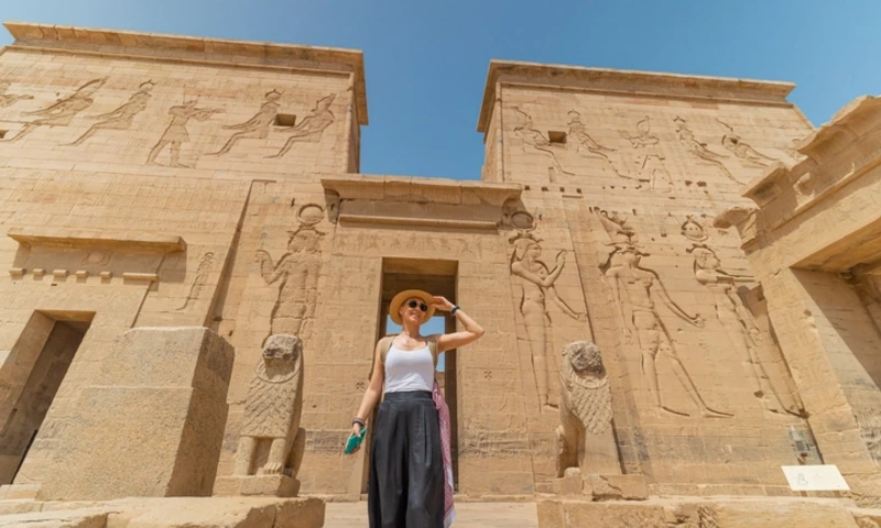 Woman walking in Temple of Isis in Aswan, Philae Temple