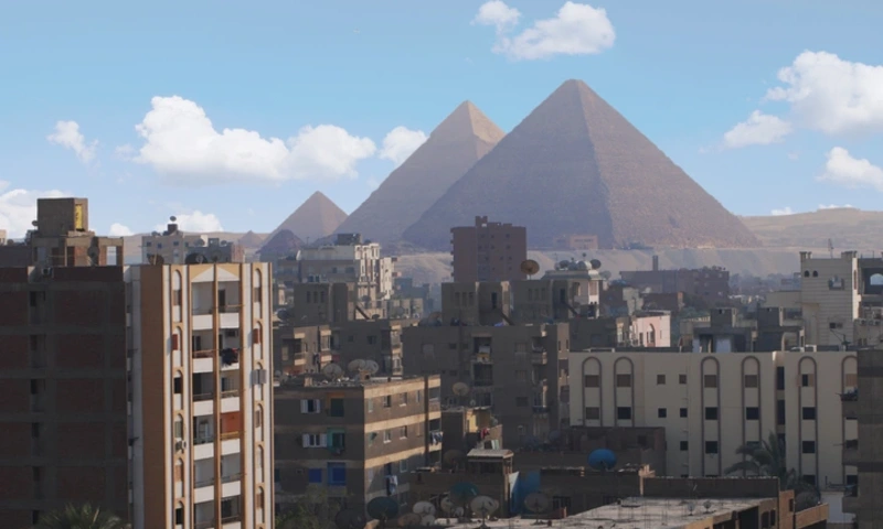 The Pyramids of Giza rising at the edge of Cairo City