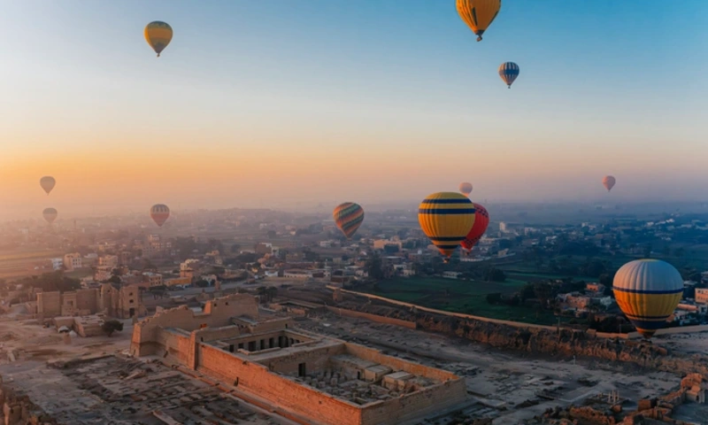Golden Sunrise Balloons Over the Ancient Medinet Habu Ruins in Luxor, Luxor Town