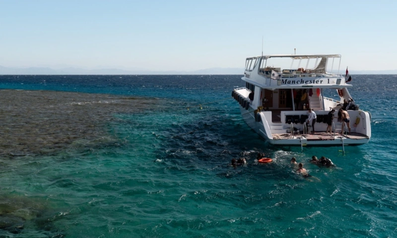 A yacht anchored near a coral reef, Dahab City