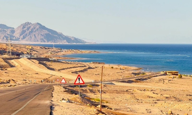 Desert coastal road along the sea with mountains, Egypt Nuweiba