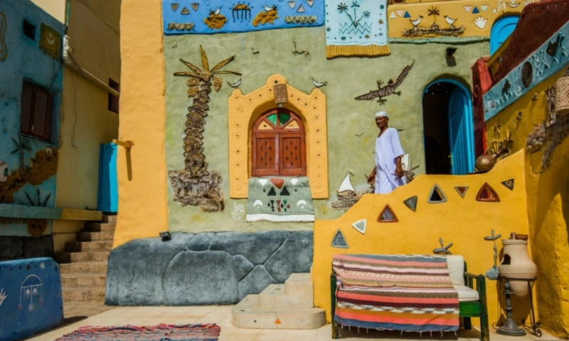 A Nubian man walks outside a traditional Nubian house, Nubian Village