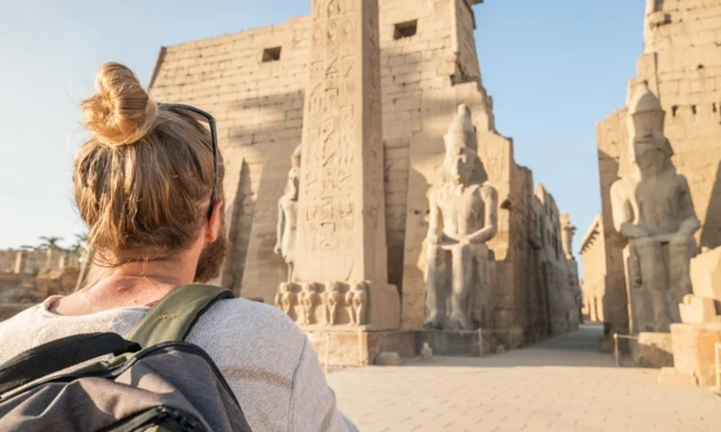 Man explores ancient temples in Egypt, Temple of Luxor