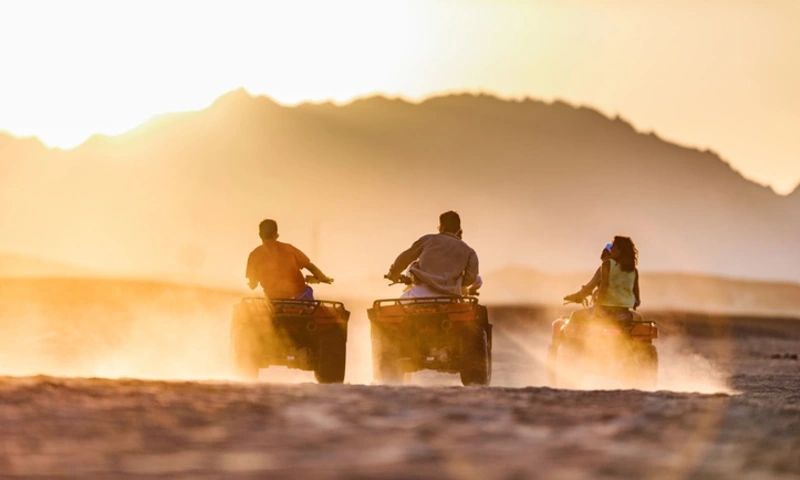 riving quad bikes in the desert at sunset, Safari Travel Tips