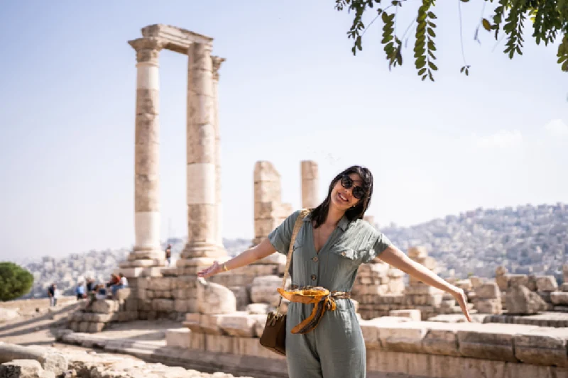 La Ciudad de Ammán. Turista feliz entre columnas antiguas, ciudad de Ammán