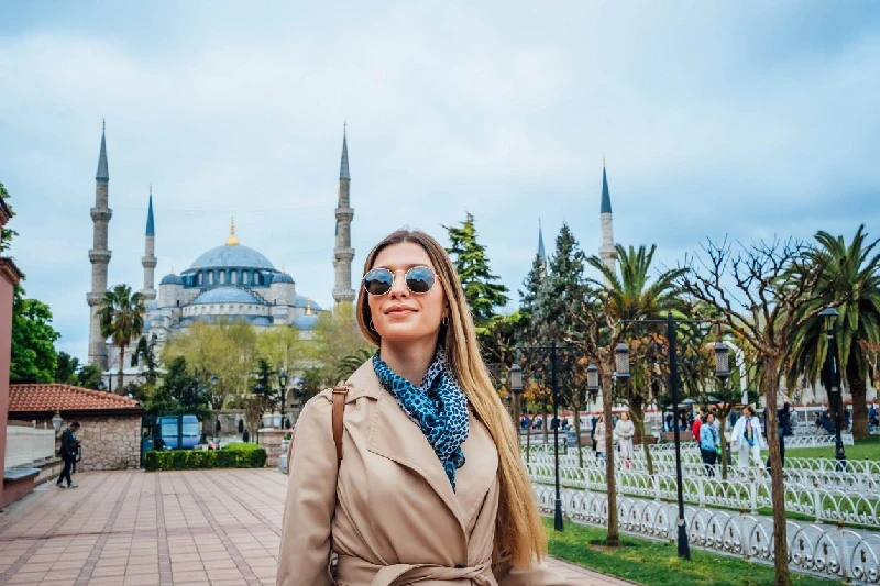 A Tourist with the Blue Mosque beautifully rising behind her.