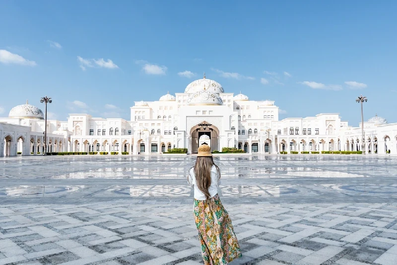 A visitor exploring the stunning Sheikh Zayed Mosque in Abu Dhabi.