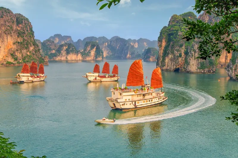 Boats sailing through the emerald waters of Ha Long Bay.