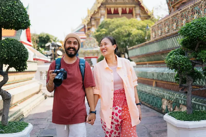 Couple enjoying their visit to Thailand’s historic Wat Phra.