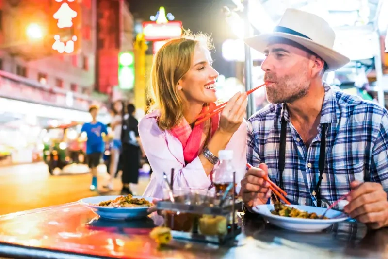 A couple enjoying a meal together in Bangkok.