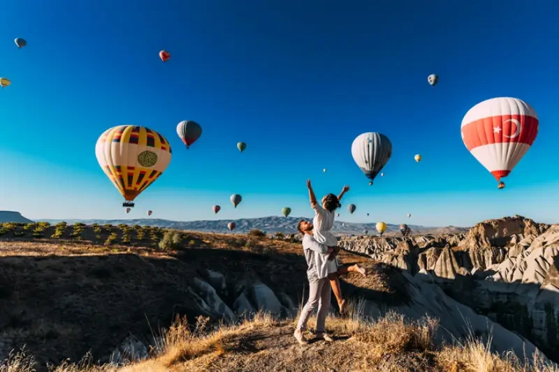 Couple watching hot air balloons in Cappadocia.