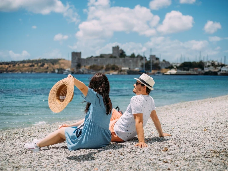 Happy couple relaxing on a beach in Bodrum, Summer in Turkey.