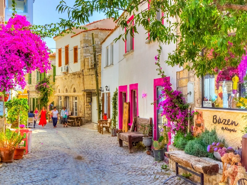 Visitors walking along Haci Memis Street in Alacati, Summer in Turkey.